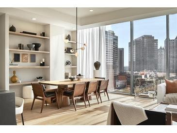 Modern dining room with large windows, hardwood floors, and a long wooden table at 40 12Th Ne St # 1005, Atlanta, GA 30309