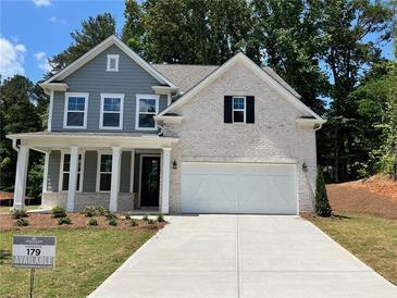 Two-story home with gray siding, white brick accents, and a three-car garage at 29 Riverbirch Ct, Dallas, GA 30157