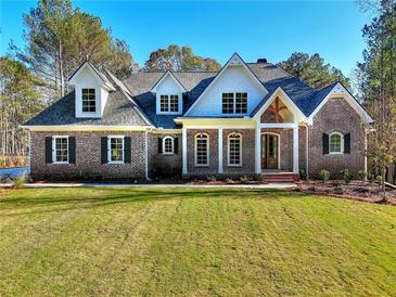 Brick home with a front yard, gray roof, and white accents at 99 Iroquois Ct, Covington, GA 30014