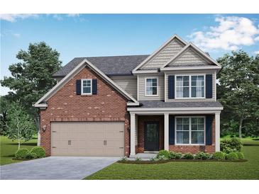 Two story house with brick facade and two car garage at 6067 Ruby Falls, Stonecrest, GA 30038