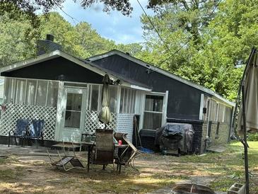 Black house with screened porch and backyard patio at 2654 Davenport Se St, Smyrna, GA 30080