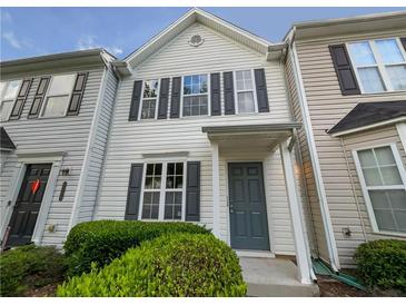 Townhouse exterior featuring a gray door and well-manicured landscaping at 6531 Arbor Gate Sw Dr # 12, Mableton, GA 30126