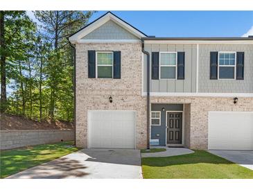Front view of a two-story townhome at 7041 Livia Pt, Riverdale, GA 30296