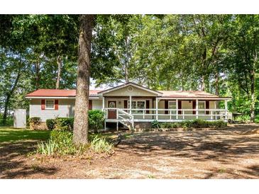 House exterior showcasing a front porch and tree-lined yard at 146 Mount Bethel Rd, Mcdonough, GA 30252