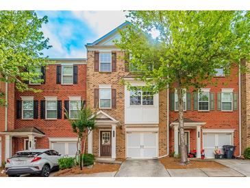 Brick townhouse with two-car garage and landscaping at 2100 Meadow Peak Rd, Duluth, GA 30097