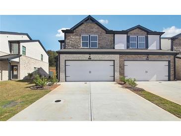Two-story townhome with stone facade and two-car garage at 269 Bald Ave # 18, Stockbridge, GA 30253