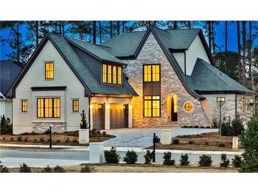 Luxury two-story home with stone accents and three-car garage at 4215 Tattnall Run, Acworth, GA 30101