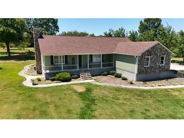 Ranch-style house with stone accents and a large yard at 3060 Habersham Cir, Covington, GA 30014
