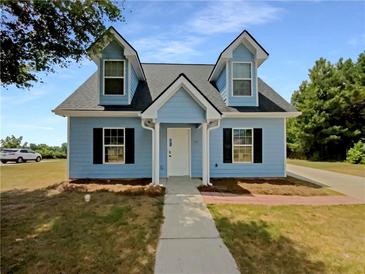 Charming light blue house with a well-maintained lawn at 6184 Avery St, Covington, GA 30014