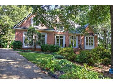 Brick home with lush landscaping and welcoming front porch at 14 Mckelvey Nw Ct, Cartersville, GA 30121