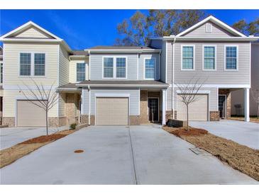 Three-unit townhome building with attached garages at 6120 Ripple Way # 46, South Fulton, GA 30349