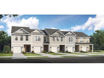 Exterior view of five townhouses with attached garages and landscaping at 6104 Ripple Way # 50, South Fulton, GA 30349