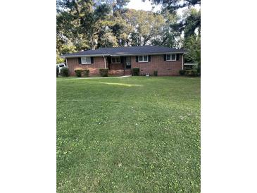 Brick ranch house with a large grassy front yard at 4193 Dunmore Rd, Decatur, GA 30034