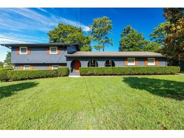 Ranch home with blue exterior and orange shutters at 2723 Slumber Trl, Decatur, GA 30034