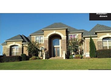Two-story brick home with large windows and landscaping at 1819 Trinidad, Stockbridge, GA 30281
