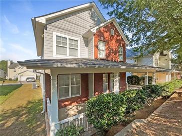 Two-story house with gray siding, brick accents, and a front porch at 4337 Ben Hill Rd, Atlanta, GA 30349