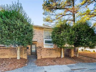 Brick townhouse exterior with landscaping and a private entrance at 4701 Flat Shoals Rd # 68D, Union City, GA 30291