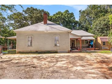 Older home with a large yard and outbuildings at 4115 Hicks Rd, Austell, GA 30106