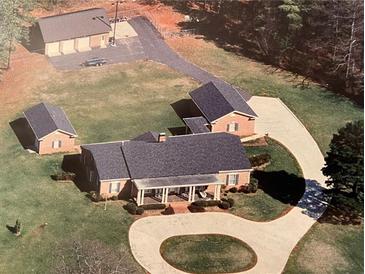 Aerial view of house, detached garages, and circular driveway at 3355 Smithtown Rd, Suwanee, GA 30024