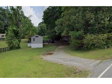Gravel driveway entrance to property with trees at 160 Scott Rd, Canton, GA 30115