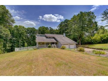 Two-story house with attached garage and large yard at 1274 Bramlett Shoals Rd, Lawrenceville, GA 30045