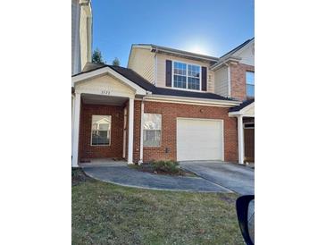 Brick townhouse with attached garage and small front yard at 2572 Laurel Cir, Atlanta, GA 30311