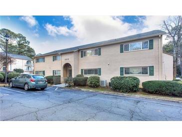 Exterior view of beige brick building with parking at 3212 Henderson Mill Rd # 2, Atlanta, GA 30341