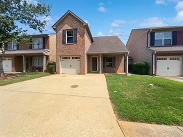 Brick home with two car garage and front yard at 313 Lauren Dr, Fairburn, GA 30213