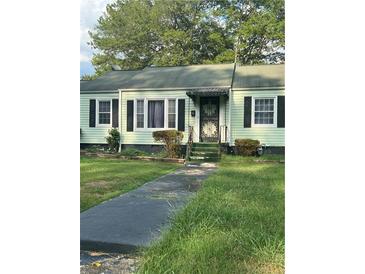 Light green house with black shutters and a small front yard at 939 Beecher Sw Ct, Atlanta, GA 30311