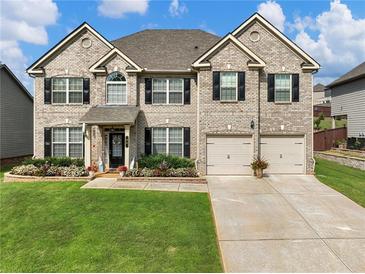 Two-story brick home with landscaping and two-car garage at 90 Piedmont Cir, Covington, GA 30016