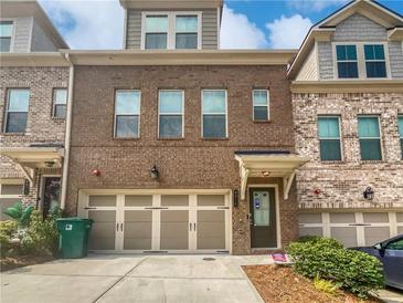 Brick townhome with two-car garage and landscaping at 6316 Brookwater Vw, Mableton, GA 30126