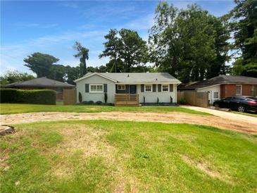 Newly painted home with a wooden deck and landscaped yard at 2653 Tilson Rd, Decatur, GA 30032