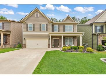 Two story house exterior with a two car garage and nicely landscaped lawn at 437 Livingston Pt, Acworth, GA 30102