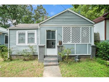 Gray house with a lattice-covered porch and small yard at , Atlanta, GA 30318