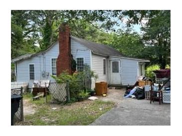 Older home needing repairs, cluttered yard at 126 Irvin St, Jonesboro, GA 30236