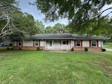 Ranch-style home with brick and siding exterior, and a well-maintained lawn at 1799 Brandy Woods Se Trl, Conyers, GA 30013