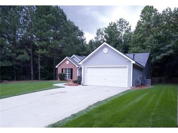 Two-toned house exterior with a driveway at 4205 Old House Dr, Conley, GA 30288