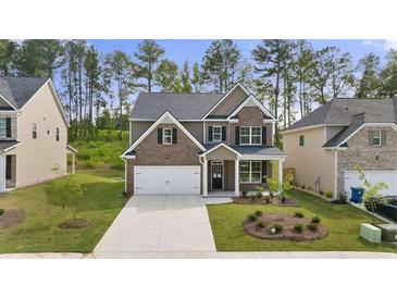 Brick home with a two-car garage and well-maintained lawn at 1698 Lacebark Elm Way, Lawrenceville, GA 30045