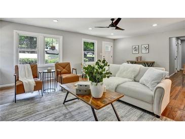 Bright living room with hardwood floors, stylish furniture, and large windows at 163 Glenrose Sw Cir, Atlanta, GA 30354