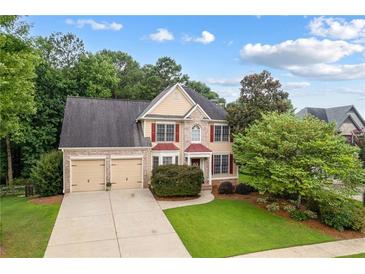 Two-story house with two-car garage and nicely landscaped yard at 209 Vine Creek Drive, Acworth, GA 30101