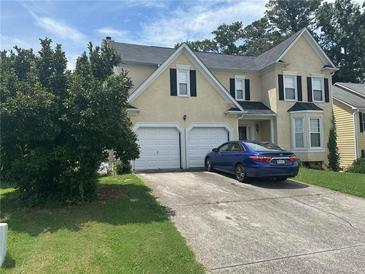 Two-story house with double garage and manicured lawn at 1080 Meadow Walk Ave, Lawrenceville, GA 30044