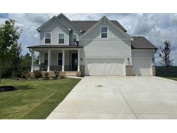 Two story home with white siding, three car garage, and front porch at 37 Ridgeline Nw Way, Cartersville, GA 30121