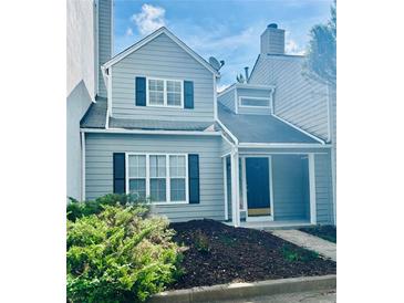 Charming two-story townhome with gray siding and black shutters at 603 Brighton Ct, Norcross, GA 30071