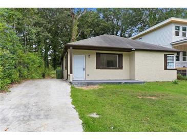 Newly renovated light beige house with a small lawn at 1410 Elizabeth Sw Ave, Atlanta, GA 30310