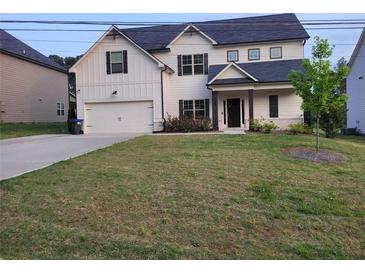 Two-story house with white siding, dark accents, and a two-car garage at 4430 Vernon Nw St, Lilburn, GA 30047