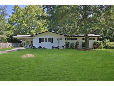 Charming ranch home with white brick exterior and lush lawn at 4340 W Linda Dr, Douglasville, GA 30134