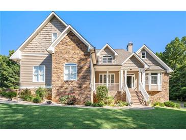 Inviting ranch home with stone and shingle accents, showcasing a well-manicured lawn at 341 Allendale Dr, Canton, GA 30115