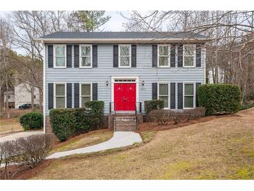 Two-story house with gray siding and red front door at 2990 Mountain Ne Trce, Roswell, GA 30075