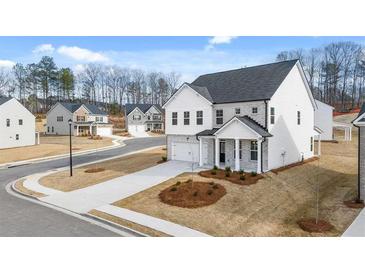 Two-story white brick home with gray roof and landscaping at 1928 Lacebark Elm Way, Lawrenceville, GA 30045