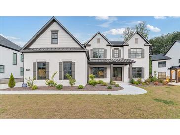 Two story white brick home with gray roof and shutters at 2899 Treeside Terrace, Marietta, GA 30066